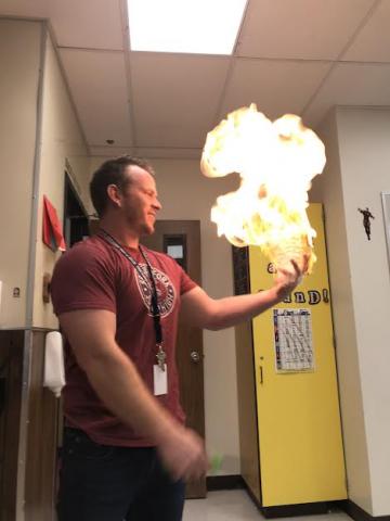 Mr. Mortimer holding fire in the palm of his hand
