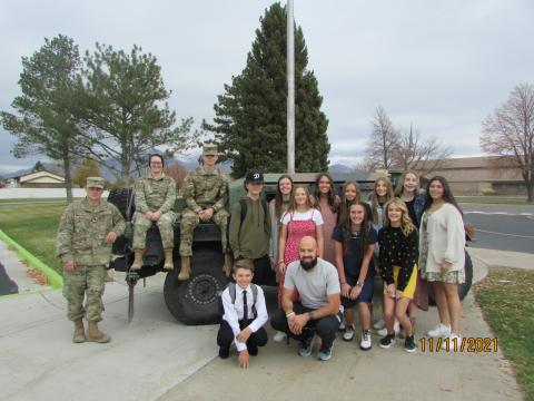 Students posing with a military Humvee and members of the Utah National Guard