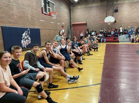 More wrestlers sitting on the bench