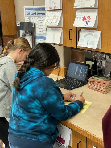 Two students reading on the computer