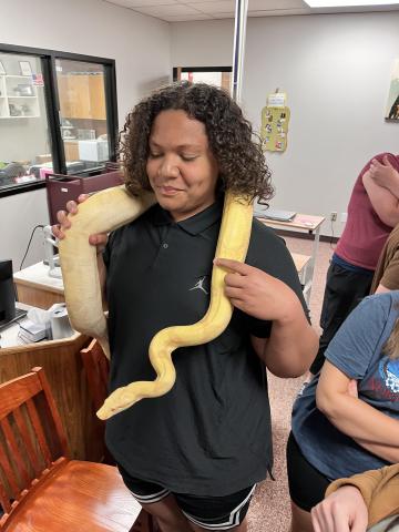 Student holding a snake