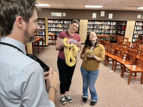 Ms. Gerroli and Mrs. Sorenson holding a snake