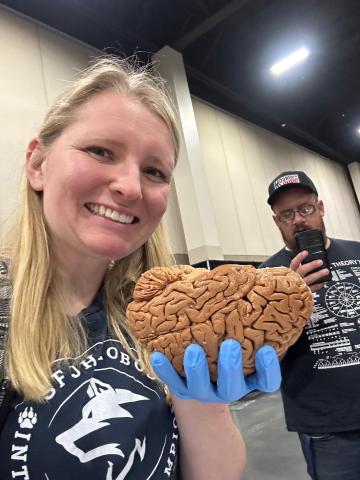 Ms. Holley holding the brain